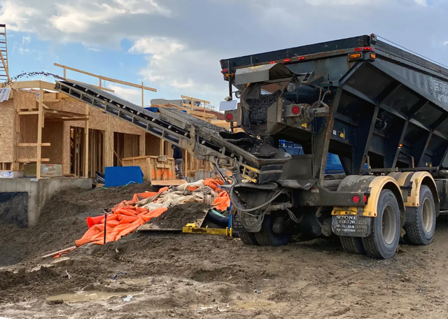 Stone slinger truck at construction site by veromix